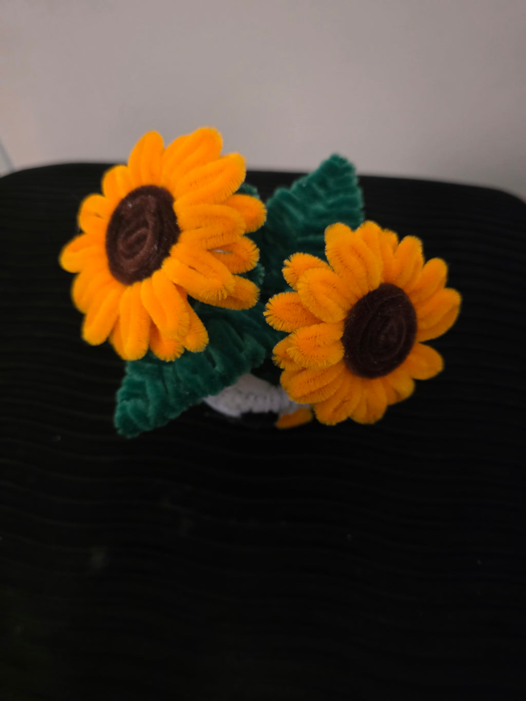 Handmade flower pot for decoration, made from pipe cleaners.