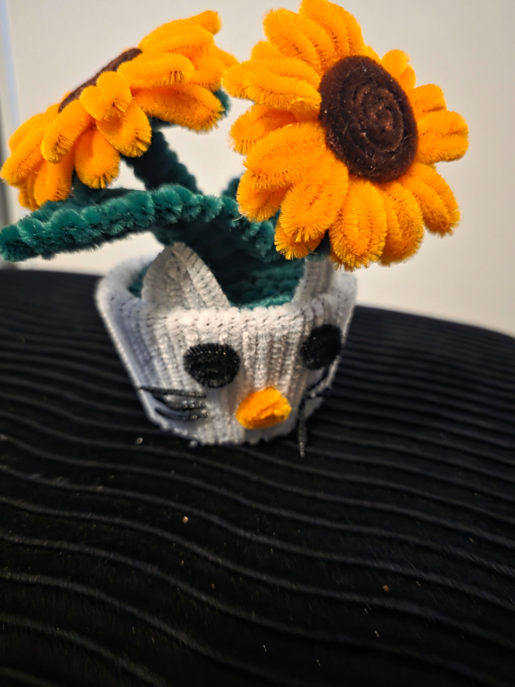 Handmade flower pot for decoration, made from pipe cleaners.