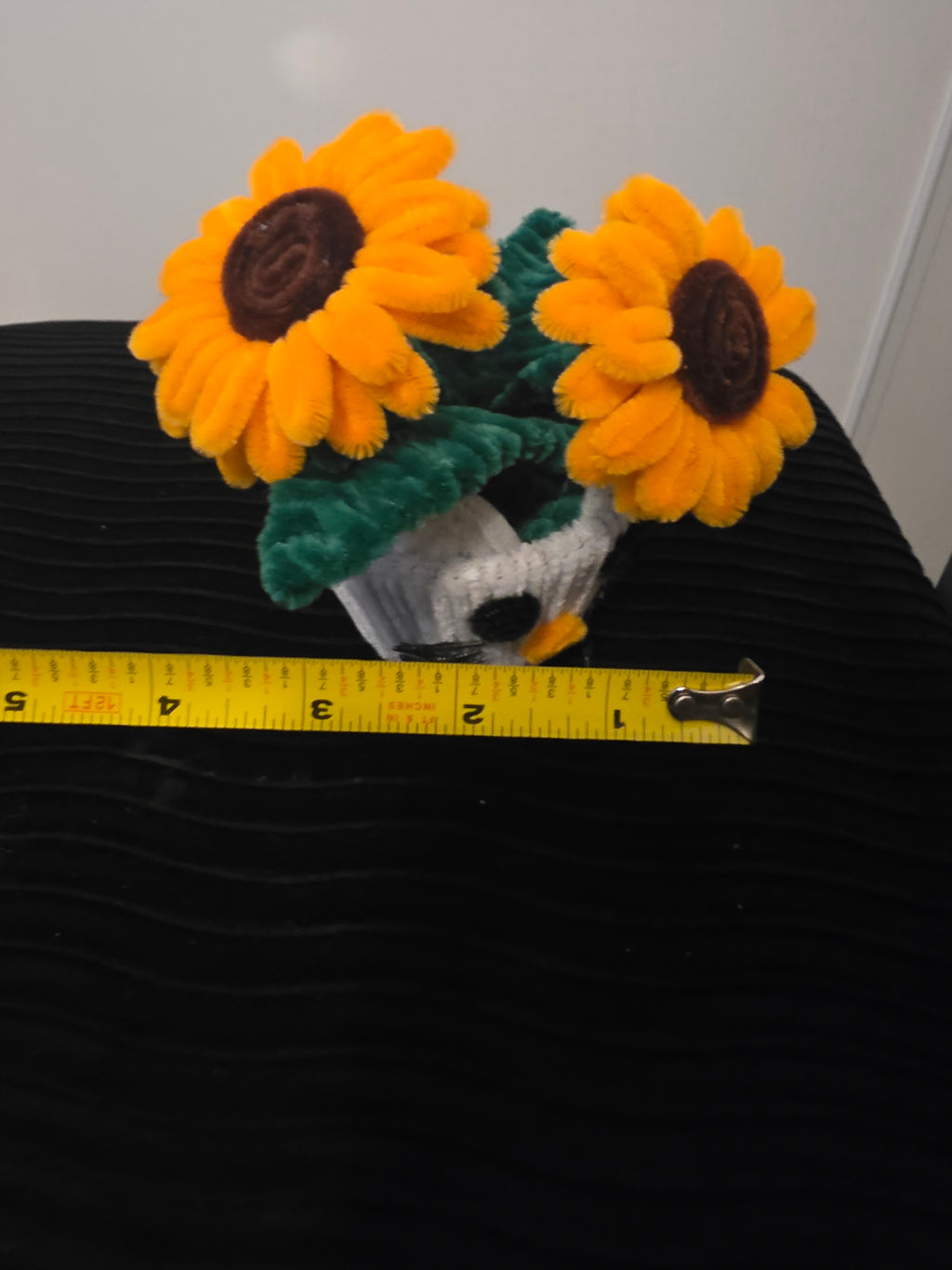 Handmade flower pot for decoration, made from pipe cleaners.